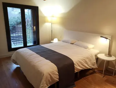 a bedroom with a large bed and a window at Beautiful 15th century villa on 30 acre estate, for families only in Alella