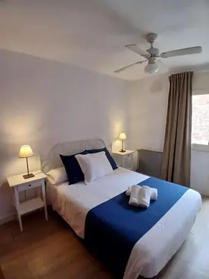 a bedroom with a large bed with two towels on it at MM4-Apto en 1ª linea de playa in Mataró