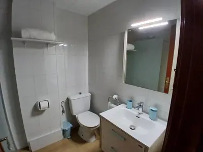 a bathroom with a toilet and a sink and a mirror at MM4-Apto en 1ª linea de playa in Mataró
