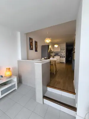a kitchen and living room with a counter in a room at MM4-Apto en 1ª linea de playa in Mataró