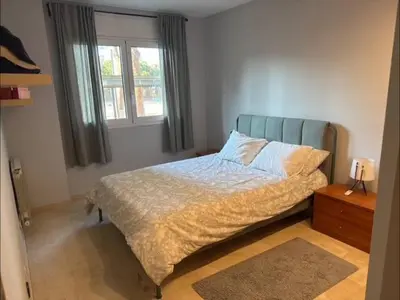a bedroom with a bed and a window at Surf&Snooze in Castelldefels