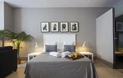 a bedroom with a bed with two pillows on it at Kare No Apartments by Sitges Group in Sitges