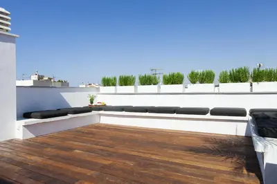a rooftop terrace with a bench on a building at Kare No Apartments by Sitges Group in Sitges