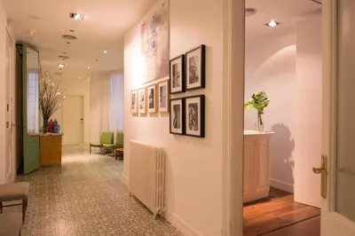 a hallway with pictures on the walls of a building at Forget Me Not Barcelona in Barcelona