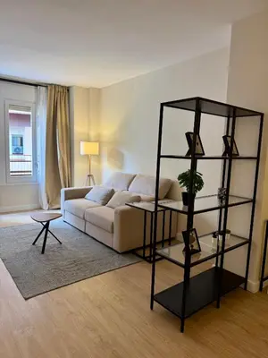 a living room with a couch and a shelf at Loft Premium en Barcelona in Barcelona