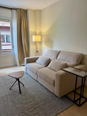 a living room with a couch and a window at Loft Premium en Barcelona in Barcelona