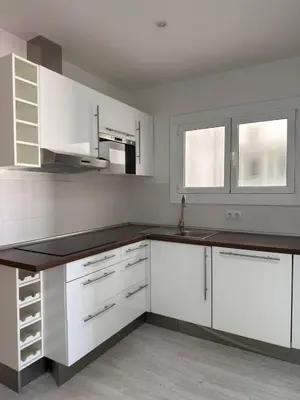 a kitchen with white cabinets and a sink at City Center 3 Bedroom Apartment! in Barcelona