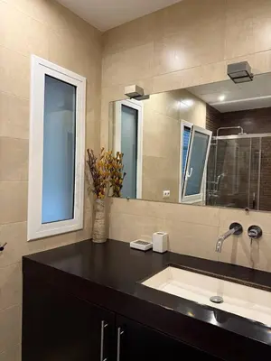 a bathroom with a sink and a mirror at Centric 2 Bedroom Apartment in Barcelona