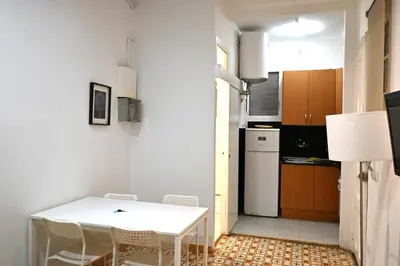 a small kitchen with a white table and chairs at Homenfun Barcelona Sants Estación in Barcelona
