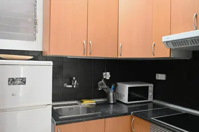 a kitchen with a sink and a microwave at Homenfun Barcelona Sants Estación in Barcelona