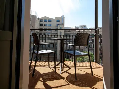 two chairs and a table on a balcony at Hotel Àmbit Barcelona in Barcelona