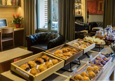 a buffet of donuts and pastries on a table at Hotel Àmbit Barcelona in Barcelona