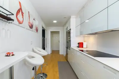 a white kitchen with white counters and white appliances at Mediterranean Soul Experience in Montgat