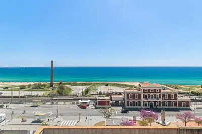 a view of a building with the ocean in the background at Mediterranean Soul Experience in Montgat