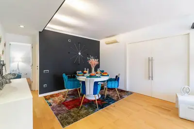 a dining room with a table and blue chairs at Mediterranean Soul Experience in Montgat