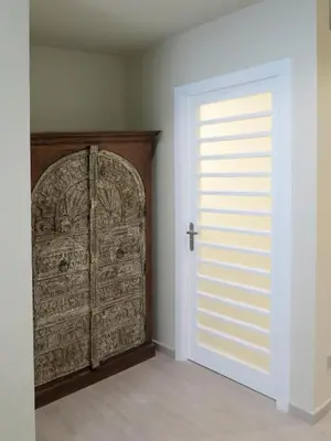 an empty room with a door and a window at Serennia Exclusive Rooms in Barcelona