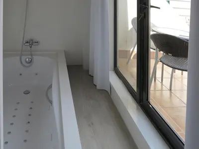 a bathroom with a shower and a glass window at Serennia Exclusive Rooms in Barcelona