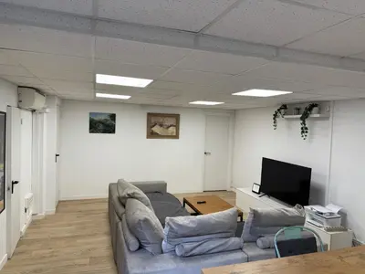 a living room with a couch and a flat screen tv at Apartamento con Piscina en sant Cugat del valles in Sant Cugat del Vallès