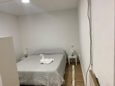 a bedroom with a bed with a swan on it at Apartamento con Piscina en sant Cugat del valles in Sant Cugat del Vallès