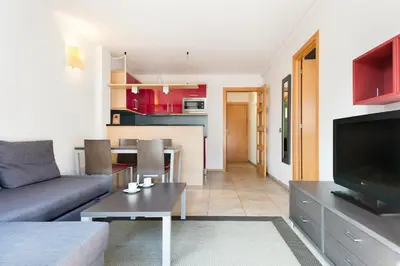 a living room with a couch and a table at Aparthotel Bardon in Castelldefels