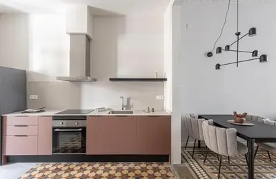 a kitchen with a sink and a living room at Canela Homes MIDTERM D'EN SERRA in Barcelona