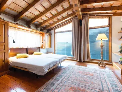 a bedroom with a bed and large windows at Cal Tomas in Castellet