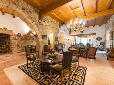 a large living room with a table and chairs at Cal Tomas in Castellet
