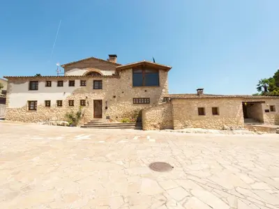 a large stone house with a stone driveway at Cal Tomas in Castellet