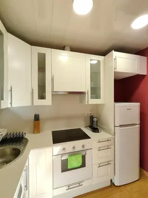 a white kitchen with white cabinets and a sink at Elegant apartment Rambla Badal in Barcelona