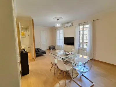 a living room with a glass table and chairs at Elegant apartment Rambla Badal in Barcelona