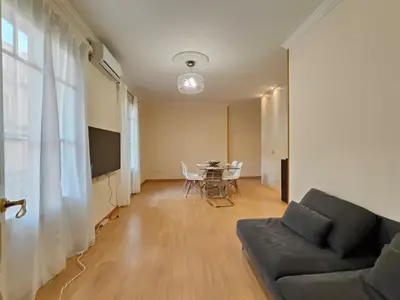 a living room with a couch and a table at Elegant apartment Rambla Badal in Barcelona