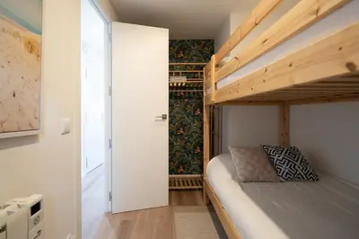 a small bedroom with a bunk bed and a closet at Castelldefels - Apartment - Sleeps 4 - Beach Side in Castelldefels