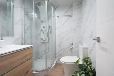 a bathroom with a glass shower and a toilet at Castelldefels - Apartment - Sleeps 4 - Beach Side in Castelldefels