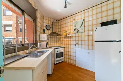 a kitchen with a sink and a refrigerator at 1º Apartamento 3 hab 15' Barcelona centro 8' Playa in Sant Adria de Besos