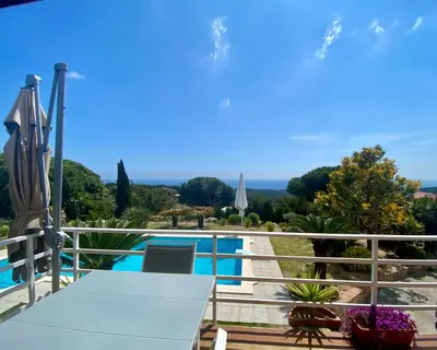 a view from the balcony of a villa with a swimming pool at CAN FENICIA - 30 min to F1 & MotoGP - Intimate Villa, Private Pool & Sea View in Arenys de Munt