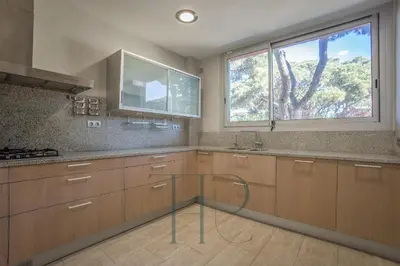 a kitchen with a glass table in the middle of it at Gavamar in Gavà