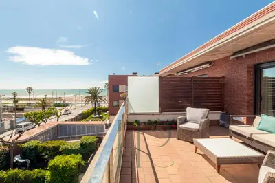 a balcony with a view of the beach at La Pineda in Castelldefels
