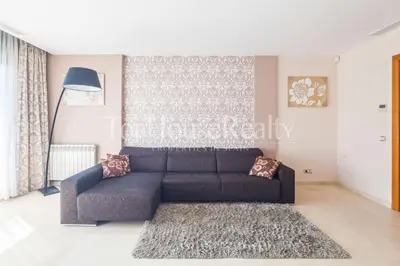 a living room with a couch and a rug at La Pineda in Castelldefels