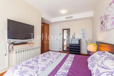 a bedroom with a bed and a flat screen tv at La Pineda in Castelldefels