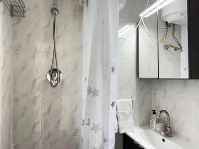 a bathroom with a shower curtain with stars on it at Atico frente al mar! in Gavà