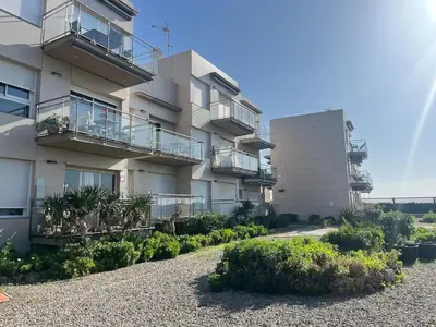an apartment building with balconies and a gravel driveway at Atico frente al mar! in Gavà