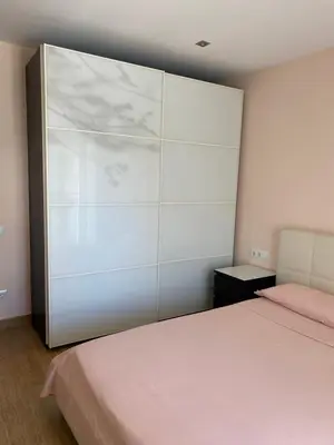 a bedroom with a bed and a large closet at House 50meters from the beach in Cunit