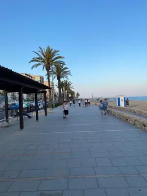 a group of people walking on a sidewalk near the beach at House 50meters from the beach in Cunit