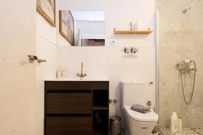 a bathroom with a toilet and a sink and a shower at Estudios a 10' caminando de la playa y a 20' de Barcelona Centro in Sant Adria de Besos