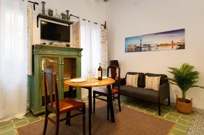 a living room with a table and a couch at Estudios a 10' caminando de la playa y a 20' de Barcelona Centro in Sant Adria de Besos
