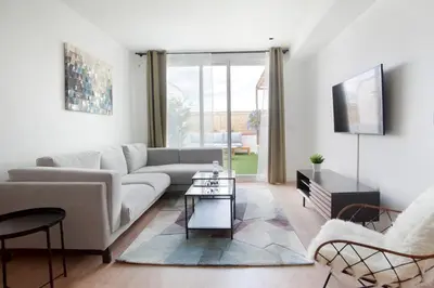 a living room with a couch and a table at Tendency Apartments 12 Penthouse in Barcelona