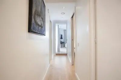 a hallway with white walls and a painting on the wall at Tendency Apartments 12 Penthouse in Barcelona