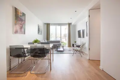 a living room with a table and some chairs at Tendency Apartments 12 Penthouse in Barcelona