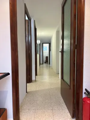 a hallway with doors and a tile floor at Vallromanes House of Peace and Rest in Vallromanas