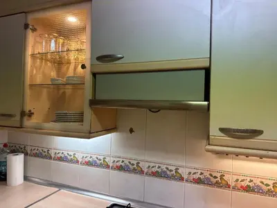 a kitchen with a glass cabinet with dishes in it at Vallromanes House of Peace and Rest in Vallromanas